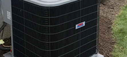 Outdoor central AC condenser unit beside a residential home