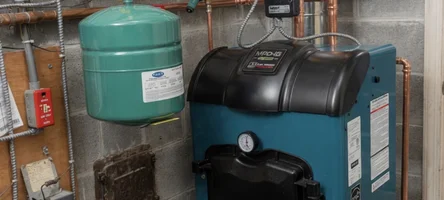 J&G technician servicing a residential boiler