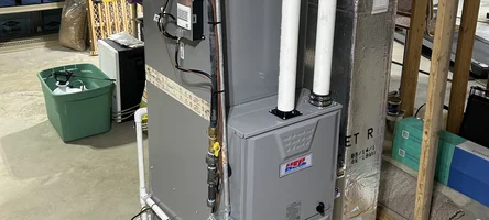 Technician inspecting a residential gas furnace
