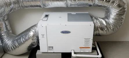Whole-home humidifier mounted to a residential ductwork system