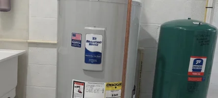 Residential tank water heater installed in a basement utility space